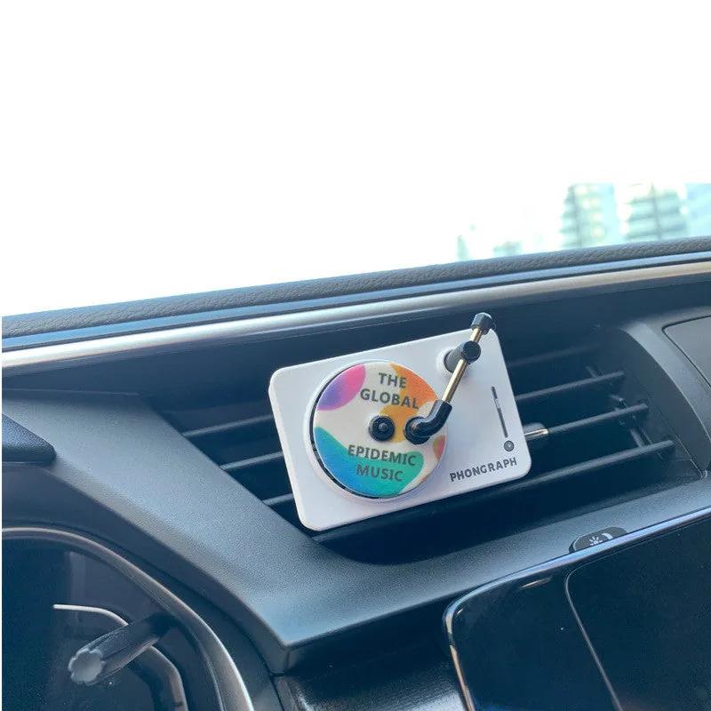 Record player vent diffuser clipped to a car air vent