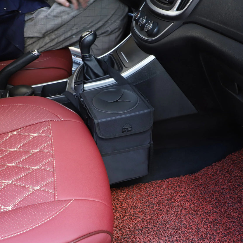 Car trash can strapped beside the centre console