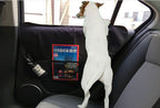 Dog standing against a pet door protection mat on a rear car door
