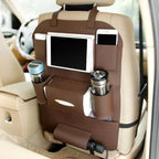 Leather seat organizer mounted on a car seat holding a tablet, drinks and a phone
