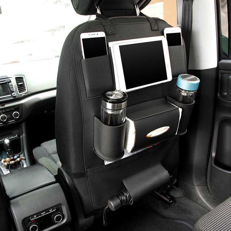 Black leather seat back organizer fitted in a car, holding a tablet, phone and two cups