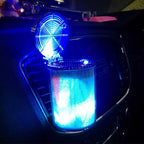 LED ashtray lit blue, sitting in a car centre console cup holder