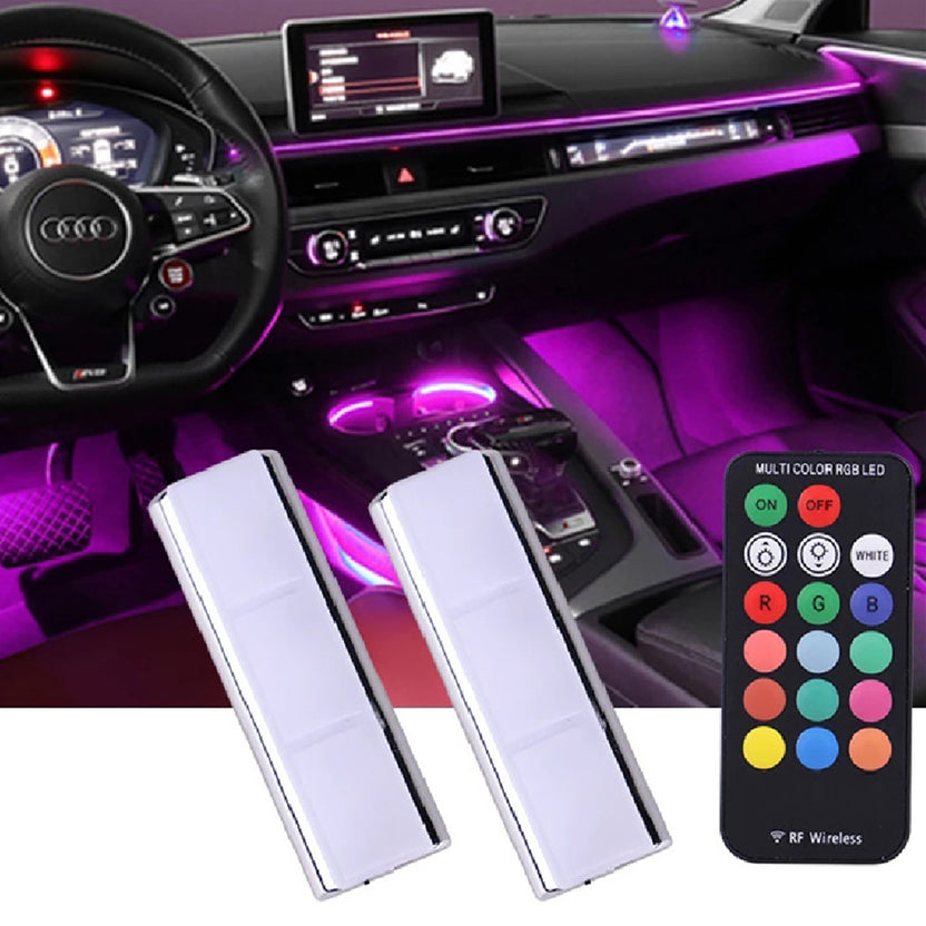 Wireless magnetic LED puck lights glowing purple in a car footwell, with remote