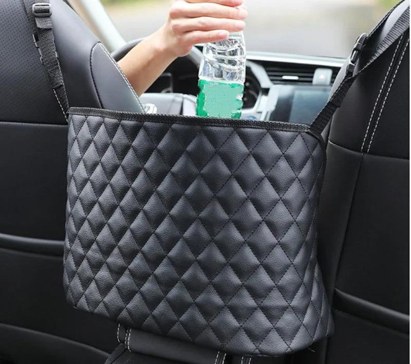 Reaching into the storage net between the front seats to lift out a water bottle