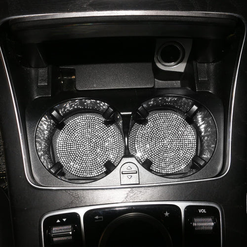 Silver crystal coasters in a car's centre-console cup holders