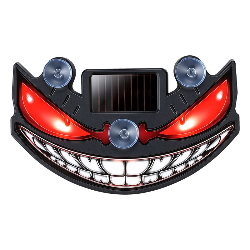 Solar devil eye window light – grinning face design, front view
