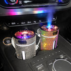 Two crystal car humidifiers glowing and misting in a centre console