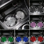 Crystal cup holder coasters in silver, purple, green, blue and red in a car console