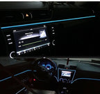 Ice blue EL wire mood line glowing along a car dashboard at night