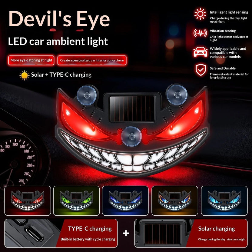 Grinning devil-eye LED car window light with crimson eyes, suction-mounted on glass at night
