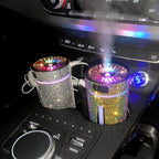 Crystal-covered car humidifier releasing mist in a centre-console cup holder