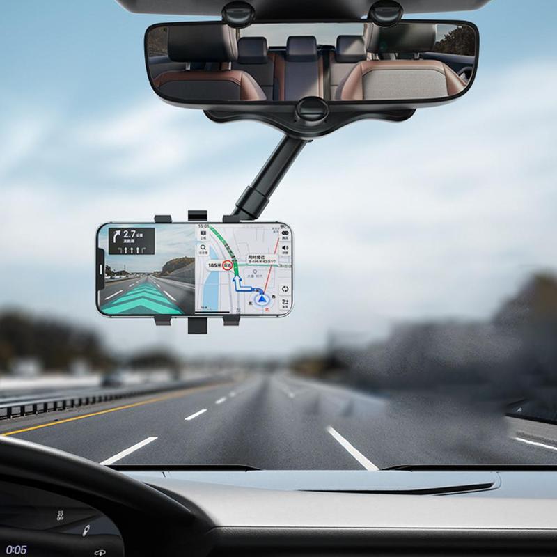 Phone mounted in the rear-view mirror holder showing navigation while driving on a motorway