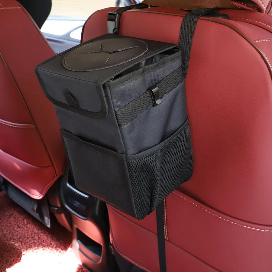 Car trash can mounted on the seat back of a dark car interior