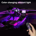 Purple ambient light line around a car dashboard and console, with remote