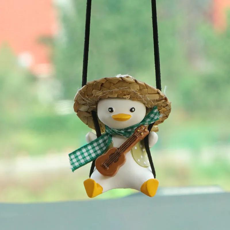 Rearview mirror charm — green duck with a violin