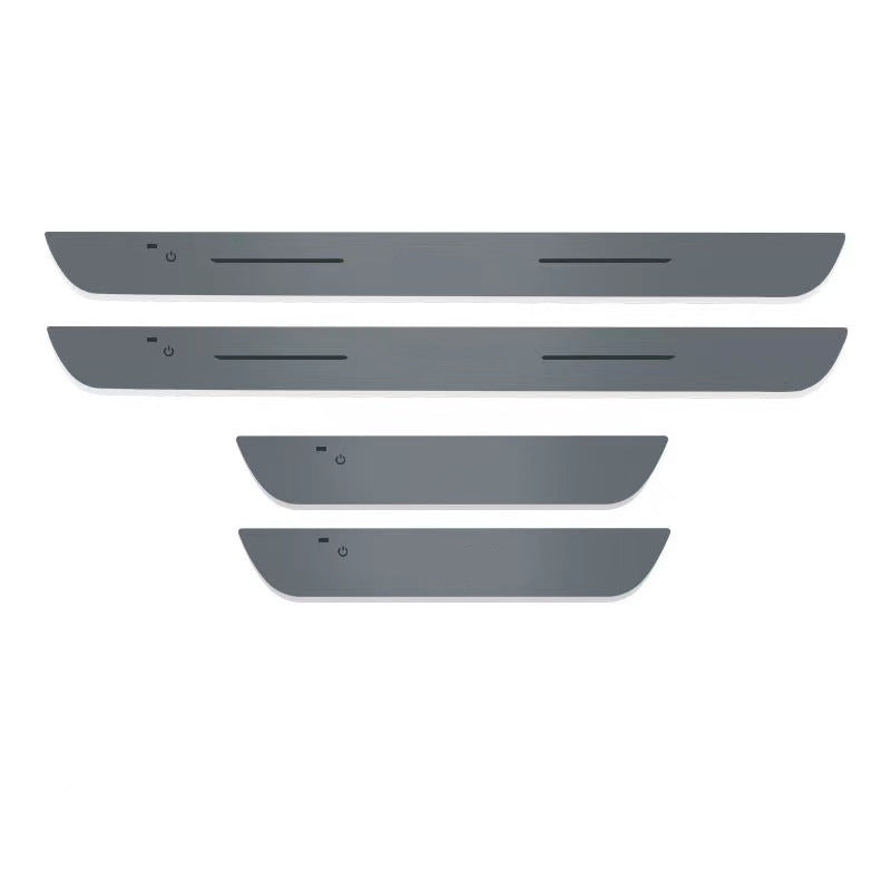 Set of four LED door sill plates, unlit on a white background