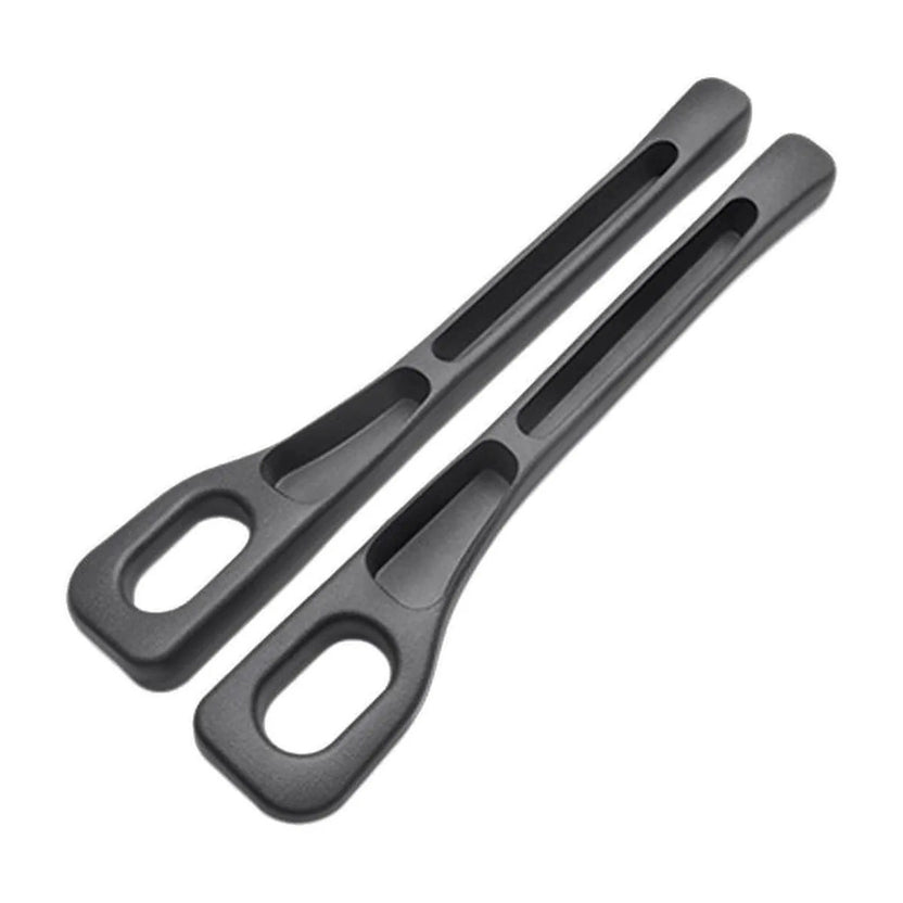 Black — pair of car seat gap filler strips on a white background