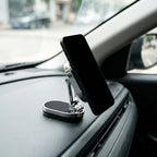 Magnetic car phone mount holding a phone on a car dashboard