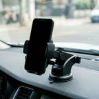 Telescopic car dashboard phone mount holding a phone at eye level