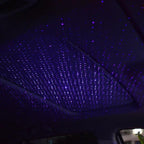 Car interior lighting bundle — the USB star projector casting a field of violet stars across a car headliner at night