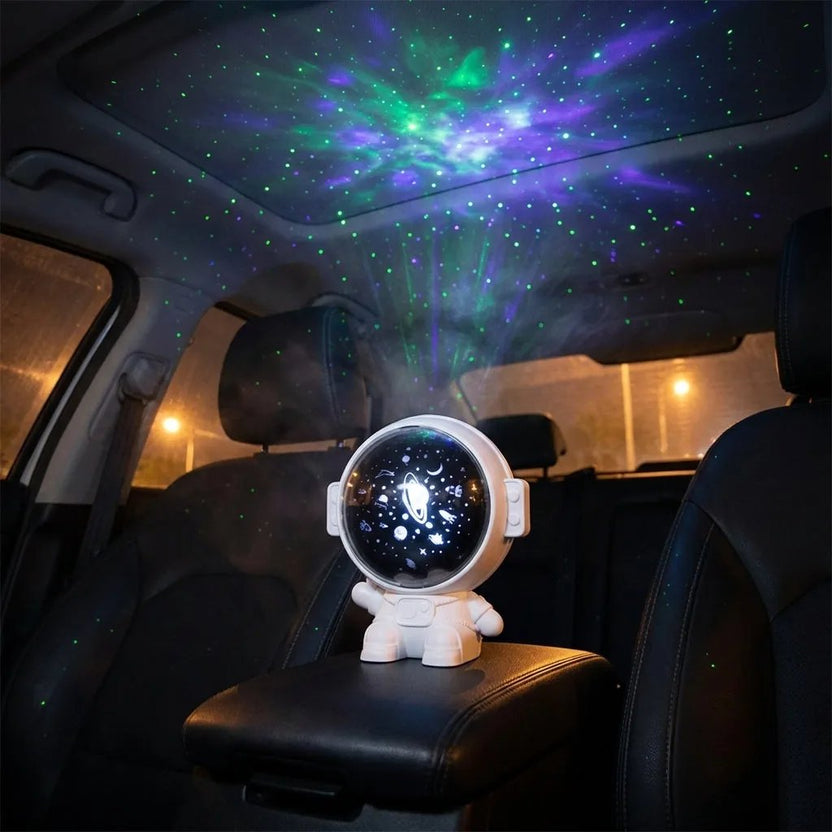Astronaut galaxy car roof projector casting stars across a car ceiling