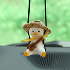 Car Rearview Mirror Charm in use — straw-hat duck with ukulele swinging in front of the windscreen